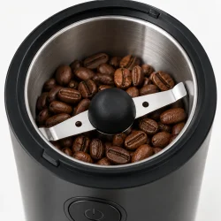 Kaffekv�rn med �bent kv�rnkammer, kaffeb�nner og to-armet kniv i rustfrit st�l.